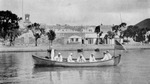 United States sailors landing at Charlotte Amalia: Fort Christian in the background